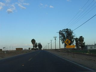 Continuing east along California 115 south and Historic U.S. 80 east, the highway again enters rural farmland east of Holtville. Here, eastbound California 115 and U.S. 80 approach Towland Road.