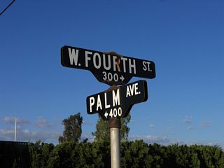 These porcelain enamel street blade signs are posted at the intersection of Fourth Street and California 115/Palm Avenue in southwestern Holtville.