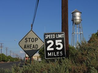 This old, porcelain enamel speed limit sign (white on black) is fairly old, but there are no date stamps on the back of the sign to confirm its age. This sign is located on Fourth Street in Holtville, less than a block after Fourth Street splits from California 115.