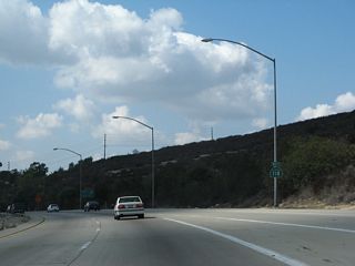 A California 118 west reassurance shield is posted after the on-ramp from Princeton Avenue. The freeway curves toward the southwest.