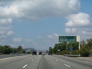 This mileage sign along California 118 west provides the distance to the next four exits: Exit 23, First Street; Exits 22B-A, Madera Road; and Exit 19B, Collins Drive.
