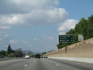 This mileage sign along California 118 west provides the distance to the next four exits: Exit 24, Erringer Road; Exit 23, First Street; and Exits 22B-A, Madera Road.