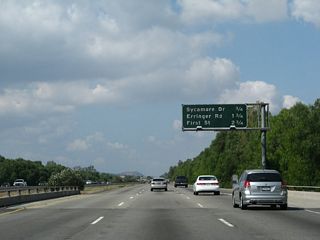 This mileage sign along California 118 (Ronald Reagan Freeway) west provides the distance to the next three exits: Exit 25, Sycamore Drive; Exit 24, Erringer Road; and Exit 23, First Street.