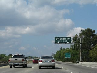 California 118 (Ronald Reagan Freeway) west approaches Exit 25, Sycamore Drive.