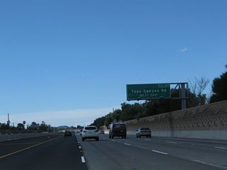 Westbound California 118 (Ronald Reagan Freeway) reaches Exit 27, Tapo Canyon Road in Simi Valley.