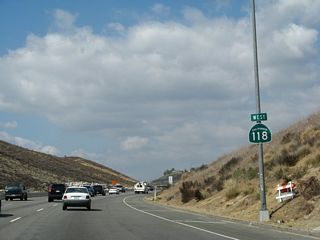 A California 118 west reassurance shield is posted after the on-ramp from Kuehner Drive.