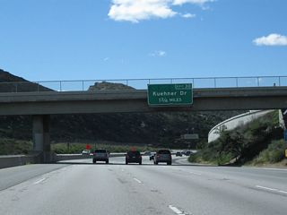 The next exit along SR 118 west is Exit 30, Kuehner Drive. The overhead sign was replaced sometime between 2007 and 2011 to include the exit number. From here, SR 118 descends into Simi Valley.