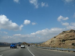 California 118 descends from Santa Susana Pass, passing by some peculiar rock formations along the way. Watch for slowing traffic on the descent into Simi Valley.