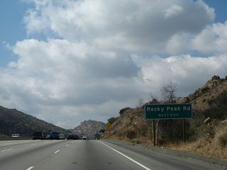 Nearing the top of the grade, westbound California 118 approaches Rocky Peak Road and Santa Susana Pass Road.