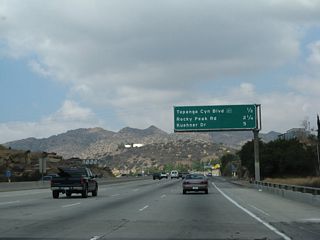 This mileage sign provides the distance to the next three exits along California 118 (Ronald Reagan [Simi Valley] Freeway) west: Exit 34, California 27 (Topanga Canyon Boulevard); Exit 32, Rocky Peak Road; and Exit 30, Kuehner Drive.