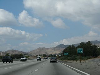 The gore point is signed with an exit number. Use Exit 36 (California 27) south to the Chatsworth Metrolink Station. Ahead, the Santa Susana Pass comes into view. California 118 will soon gain elevation to ascend the mountains and continue west into Simi Valley in Ventura County.