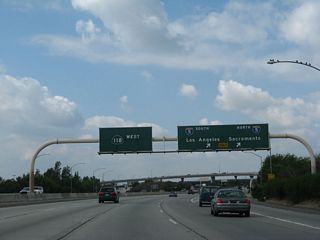 Quickly thereafter, westbound California 118 (Simi Valley / Ronald Reagan Freeway) meets Exit 44A, Interstate 5 (Golden State Freeway). Interstate 5 travels north to Santa Clarita, Sacramento, Redding, Eugene, Portland, and Seattle before ending at the International Border with Canada. To the south, Interstate 5 travels past downtown Los Angeles (staying closer to East Los Angeles and Boyle Heights), then continues toward Anaheim, Santa Ana, Irvine, Oceanside, and San Diego (ending at the International Border with Mexico).