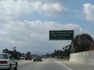 The next exit on California 118 (Simi Valley Freeway) west is Exit 44B, San Fernando Road (old U.S. 6-99). U.S. 99, the Main Street of California, used to extend from Calexico north to the Oregon border near Yreka until it was decommissioned in stages beginning in 1964. In the greater Los Angeles area, U.S. 99 was replaced by Interstate 10 from Indio west to downtown Los Angeles and by Interstate 5 from downtown north to Wheeler Ridge, where it split off onto California 99. U.S. 6 was also eliminated from Los Angeles in 1964, and it now terminates in Bishop where it meets U.S. 395 in the Eastern Sierra. Remnants of the old road include San Fernando Road, which used to carry both U.S. 6 and U.S. 99 from the north into Los Angeles.