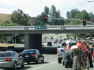 Soon thereafter, Magic Mountain Parkway approaches the left turn to Interstate 5 south. The parkway then connects with The Old Road (Old U.S. 99) and Six Flags Magic Mountain Amusement Park.