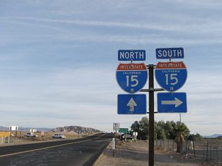 A diamond interchange joins SR 127 with Interstate 15 to the immediate south of Baker Boulevard.