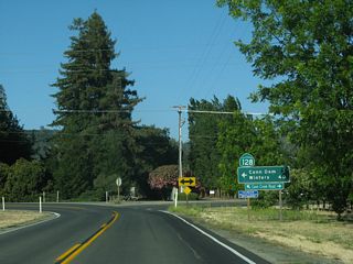 Eastbound SR 128 overtakes Conn Creek Road north from a sharp turn to avoid Caymus Vineyards.