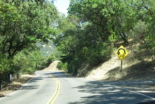 Dropping 250 feet in elevation, SR 128 navigates through a series of switchbacks and sharp curves along the west side of Redwood Mountain.