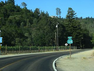 This California 128 east shield is posted along Sage Canyon Road after the intersection with Silverado Trail.