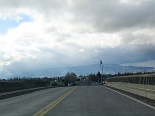 The city of Winters comes into view and old style concrete bridge rail is notable as SR 128 crosses over Interstate 505.