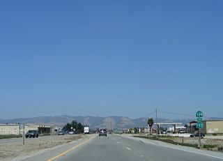 The first reassurance shield on westbound California 129 is posted after the California 1 north off-ramp, which forms a new right lane and makes California 129 into a four-lane, divided highway. California 129 is posted as To California 152 so that through traffic can connect to California 152 without driving through downtown Watsonville.