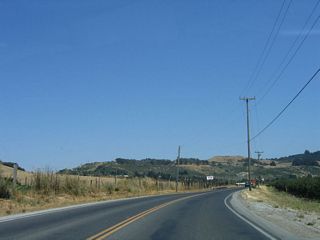 Pajaro Gap briefly widens out prior to reaching the Aromas cut off, and California 129 again passes by farms and ranches. At the Rogge Lane intersection (not photographed), turn south to the community of Aromas.