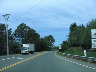 Leaving downtown Tiburon (which is Spanish forshark) and after the signalized intersection with Mar W Street and Lagoon Road/Cove Road, Tiburon Boulevard assumes a more typical state highway feel, with two lanes and standard state signage. The first reassurance shield is just ahead.