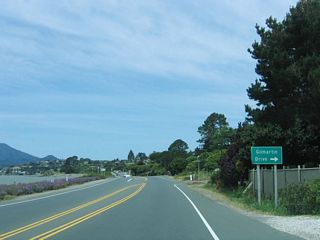 Again hugging Richardson Bay, westbound California 131 (Tiburon Boulevard) approaches Gilmartin Drive. The land fill to the southwest of California 131, which today serves as a greenbelt, was filled by Caltrans back when the extended four-lane highway was planned for the California 131 route. Once plans for the expressway/freeway were tabled in 1980, the fill became part of a greenbelt park, known as McKegney Green and the greenbelt adjacent to Knoll Park.&sup1;