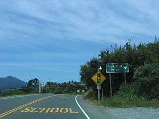 The next traffic signal along westbound California 131 (Tiburon Boulevard) is Rock Hill Drive.