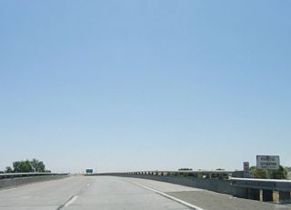 A "Route 132 Separation" bridge identification sign is posted on eastbound California 132 as it crosses over Interstate 580 (William Elton Brown Freeway).