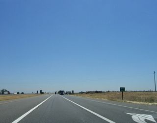 The only intersection between Chrisman Road and Interstate 5 is this junction with Bird Road. Note that the left turn is dedicated for those turning north onto Bird Road to Tracy, while the right lane turns south on Bird Road. The middle lane continues east along California 132.