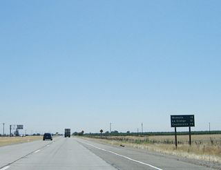 This mileage sign along eastbound California 132 provides the distance to Modesto/California 99 (19 miles), La Grange/Stanislaus County Route J-59 (51 miles), and Coulterville/California 49 (75 miles).
