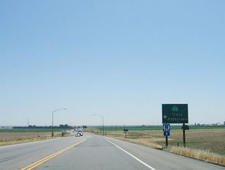 Eastbound California 132 meets the connecting road to California 33 at this left turn. Trucks should continue straight ahead toward Modesto.