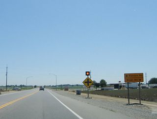 The next major intersection (after McCracken Road) along eastbound California 132 (Maze Boulevard) is Stanislaus County Route J-4 (Kasson Road) north to Tracy and Lathrop and south via River Road to Grayson.