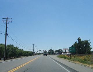 Continuing east, a traffic signal is found at Hart Road, which is the next major intersection along eastbound California 132 (Maze Boulevard).