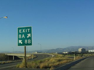 This gore point sign on the transition ramp from northbound California 133 to Interstate 405 is unusual in that the left lane becomes Exit 8B while the right lane becomes Exit 8A.