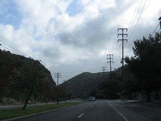 California 133 widens out to a four-lane divided highway standard as we leave the urbanized area. Note the divoted curbing along the median; this dates back to older state highway standards.