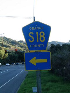 After the California 73 interchange, southbound California 133 approaches the intersection with El Toro Road (Orange County Route S-18). This is one of the few signed county routes in Orange County. Orange County Route S-18 follows a rather convoluted route from this intersection to the northeast toward Santiago Canyon.