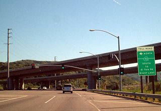 California 133 meets California 73 (San Joaquin Hills Transportation Corridor) (Toll) at this interchange. The first ramp links California 133 south to California 73 north. Use California 73 north to Long Beach as well as coastal cities, such as Newport Beach and Huntington Beach. However, it is not as scenic as California 1.