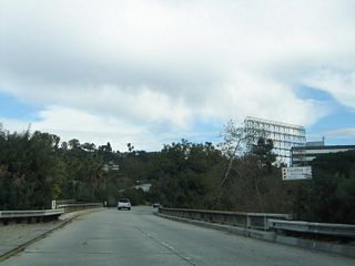 The bridge spanning Figueroa Street along the Colorado Freeway also features divoted curbing. An entrance ramp follows this grade separation from Figueroa Street before the Colorado Freeway converges with the Ventura Freeway.