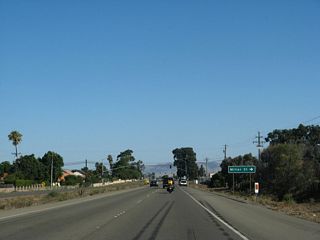 Northbound California 135 (Broadway) approaches Miller Street. Broadway retains expressway standards for a little while longer before becoming a conventional city street.