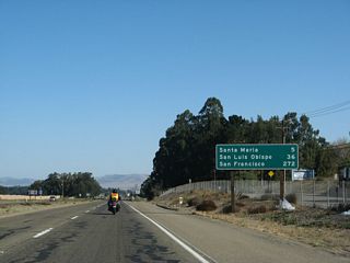 After the Clark Avenue interchange, this mileage sign provides the distance to Santa Maria (five miles), San Luis Obispo (36 miles), and the control city of San Francisco (272 miles).