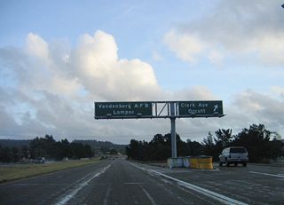 Southbound California 135 (Orcutt Expressway) meets Exit 17, Clark Avenue. The pull-through sign for Vandenberg Air Force Base and Lompoc omit the California 135 shield, perhaps because both of these destinations are served by California 1 (Cabrillo Highway) rather than California 135.
