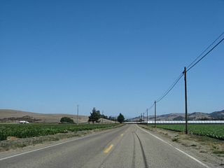 California 135 continues east through agricultural areas en route toward Los Alamos, crossing the San Antonio Creek along the way.