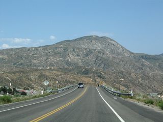 Leaving Mormon Rocks, eastbound California 138 passes over the Burlington Northern Santa Fe (BNSF) Railroad and descends toward its junction with Interstate 15, which travels south to San Bernardino, Riverside, and San Diego or north to Victorville, Barstow, and Las Vegas. California 138 will continue through this interchange to Cajon Pass, Silverwood Lake, Valley of Enchantment, and Crestline.