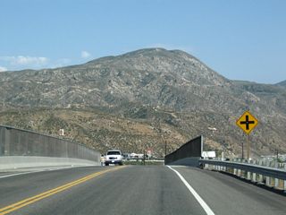 Eastbound California 138 passes over the Burlington Northern Santa Fe (BNSF) Railroad. The freeway comes into view after this rise.