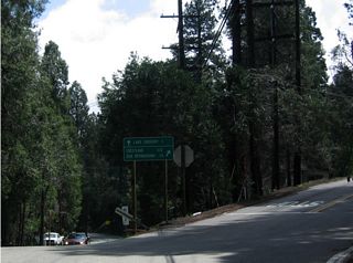 This fork in the road, along eastbound just prior to reaching downtown Crestline, splits California 138 east and Lake Gregory Drive. The left turn leads to Lake Gregory, then meets California 18 east of Twin Peaks. Continuing to the right follows California 138 to Crestline and California 18 south to San Bernardino.