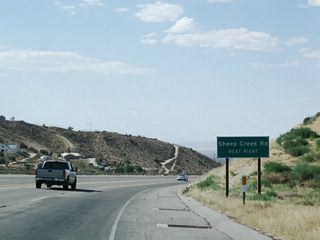 A second advance guide sign is posted along westbound California 138 for Sheep Creek Road in Phelan.