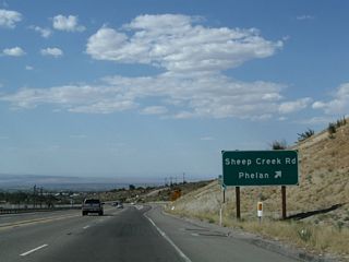 Westbound California 138 meets Sheep Creek Road in Phelan. Use Sheep Creek Road north to the central business district of Phelan, which is located at the intersection of Sheep Creek Road and Phelan Road. Phelan, an unincorporated community in western San Bernardino County, had a population of 14,304 as of the 2010 Census and sits at an elevation of 3,993 feet.