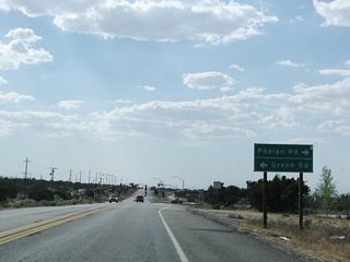 Westbound California 138 approaches Phelan Road east and Green Road west.
