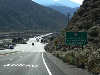Westbound California 138 approaches Interstate 15, which travels north to Victorville, Barstow, and Las Vegas or south to San Bernardino, Riverside, and San Diego.